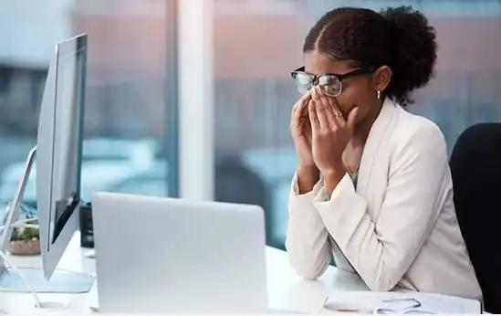 worried physician in front of computer