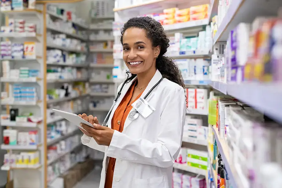 young pharmacist using digital tablet