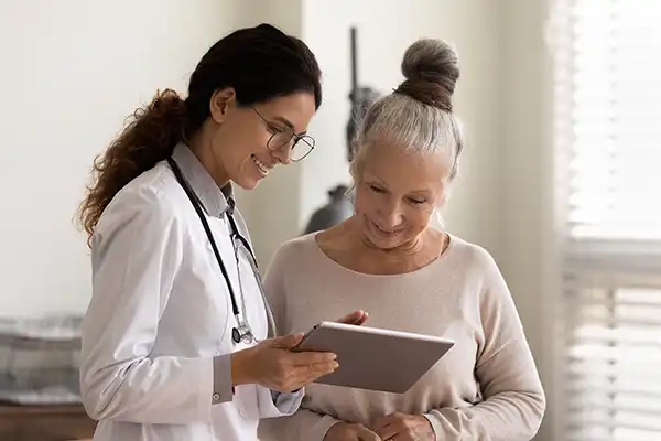 Female physician discussing medical reports with female patient