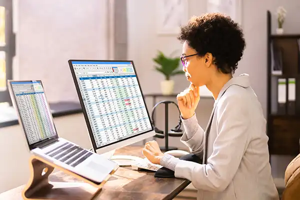 Medical Coder working with two screens