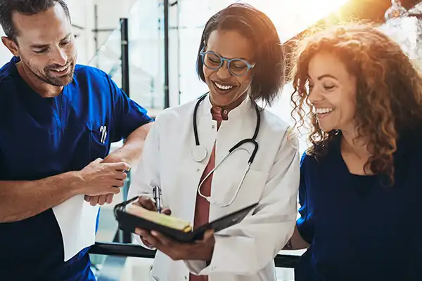 Medical staff smiling with notebook in hand