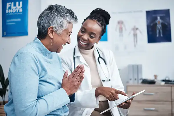 aged lady thanking female physician