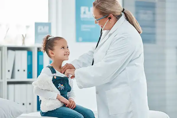 female doctor checking young female kid