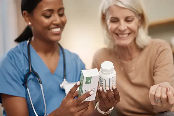 female physician checking medicines with a lady patient