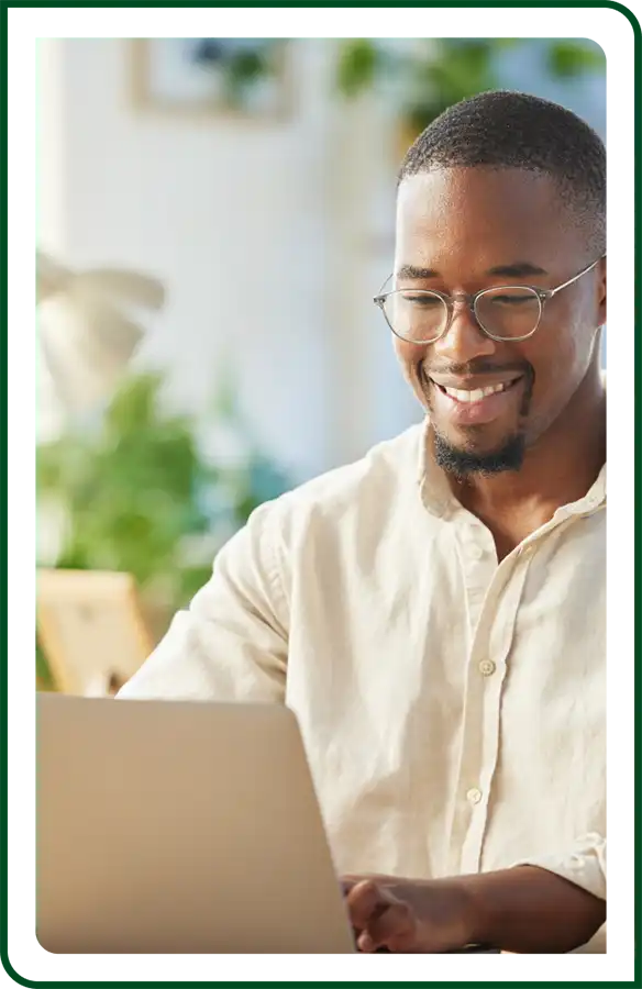 young man smiling with laptop