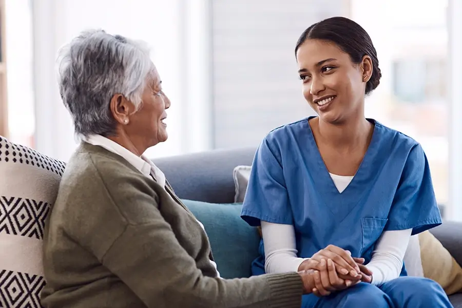 a young nurse chatting to a senior woman