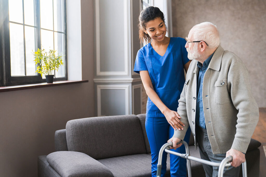 young nurse helping old elderly disable man