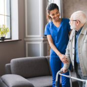 young nurse helping old elderly disable man