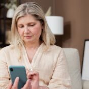 woman-holding-smartphone-using-mobile-app