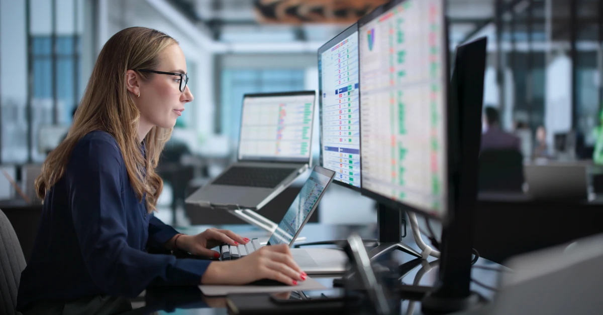 Woman In Office Using Laptop