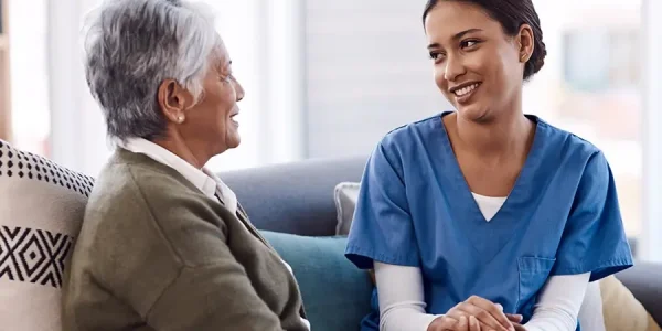 a young nurse chatting to a senior woman