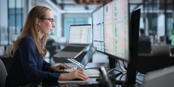 Woman In Office Using Laptop