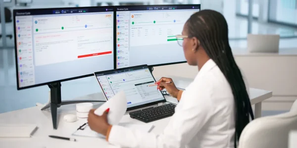 Young-Woman-Uses-Laptop-To-Review-Medical-Billing