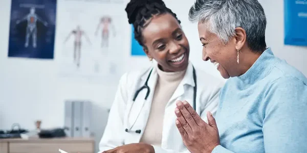 doctor and elderly patient interacting