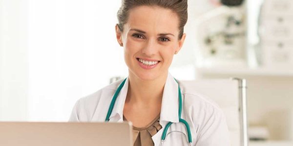happy physician with laptop