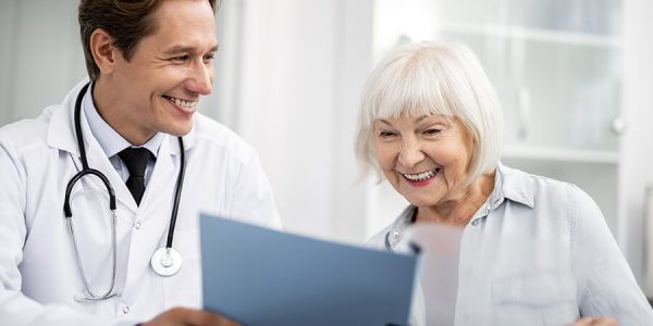 smiling-to-his-happy-elderly-patient